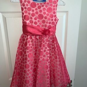 Pink formal kids dress with polka dots.